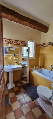 a bathroom with a tub and a sink and a toilet at Maison accès direct plage corse du sud in Coti-Chiavari