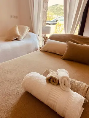 a couple of beds with towels on top of them at bergerie-ucaseddu in Zonza
