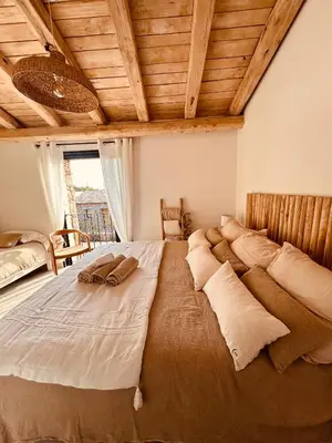 a large bed in a room with a wooden ceiling at bergerie-ucaseddu in Zonza