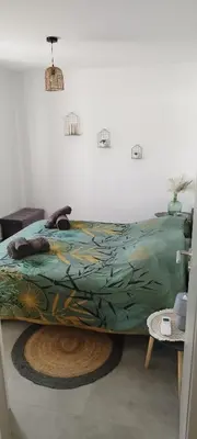 a bed with a colorful comforter in a room at Appartement Lelia in Sotta