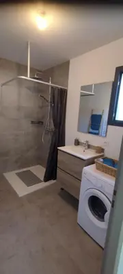 a bathroom with a shower and a washing machine at Appartement Lelia in Sotta