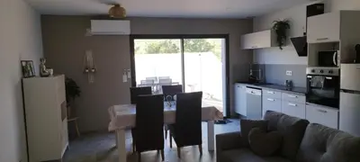 a kitchen and dining room with a table and chairs at Appartement Lelia in Sotta