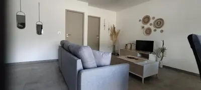 a living room with a couch and a tv at Appartement Lelia in Sotta