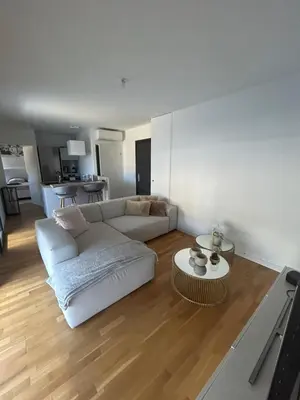 a living room with a white couch and a table at Appartement T2 très bon standing ! in Ajaccio