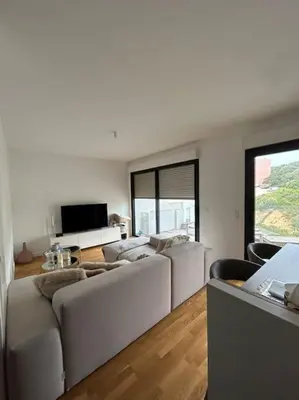 a living room with white furniture and a large window at Appartement T2 très bon standing ! in Ajaccio