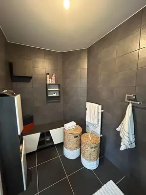 a bathroom with two baskets on a tiled wall at Appartement T2 très bon standing ! in Ajaccio