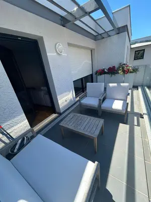a patio with two chairs and a table on a balcony at Appartement T2 très bon standing ! in Ajaccio