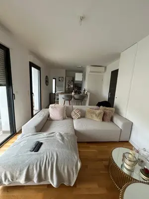 a living room with a white couch and a table at Appartement T2 très bon standing ! in Ajaccio