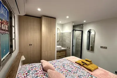 a bedroom with a bed and a bathroom with a sink at Appartement T2 Vue Mer Porticcio in Porticcio