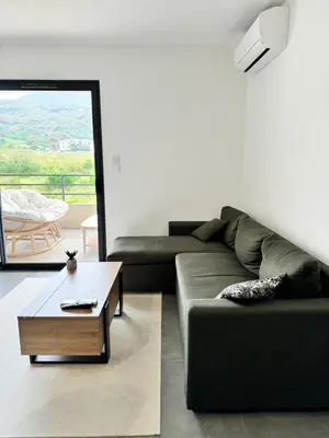 a living room with a couch and a coffee table at Logement calme et agréable in Borgo