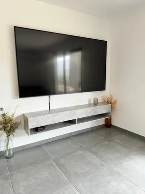 a large flat screen tv on a wall at Logement calme et agréable in Borgo