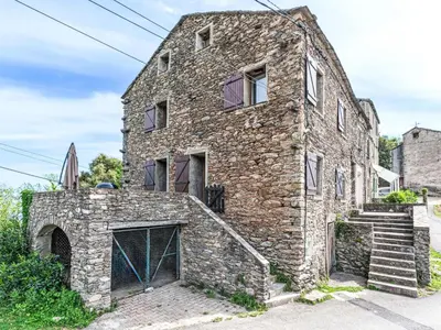 an old stone building with a staircase in front of it at Holiday Home Piana by Interhome in San-Giovanni-di-Moriani