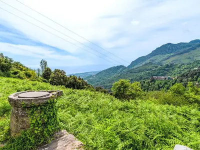 a stone pillar on a hill with mountains in the background at Holiday Home Piana by Interhome in San-Giovanni-di-Moriani