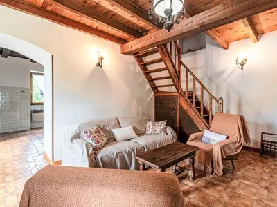 a living room with a couch and a staircase at Holiday Home Piana by Interhome in San-Giovanni-di-Moriani