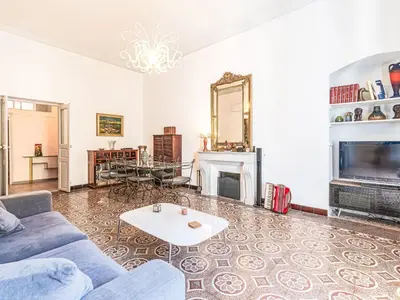 a living room with a blue couch and a fireplace at Apartment Casa Grandval by Interhome in Ajaccio