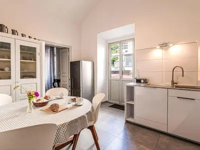 a kitchen with a table and chairs in a kitchen at Apartment Casa Grandval by Interhome in Ajaccio