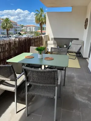 a table and chairs on a balcony with a view at MORIANI Plage T2 terrasse proche mer et commerces in Moriani Plage