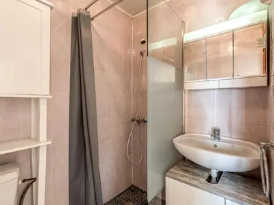 a bathroom with a sink and a shower at Holiday Home Campestra by Interhome in Coti-Chiavari