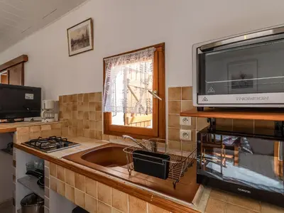 a kitchen with a sink and a microwave at Holiday Home Campestra by Interhome in Coti-Chiavari