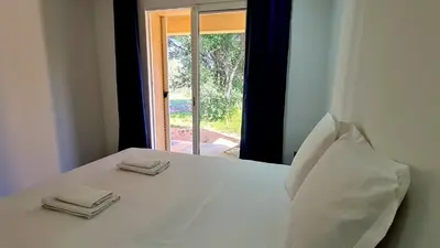 a white bed with two napkins on top of it at Havre de paix, 5 min de la mer in Zonza