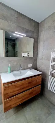 a bathroom with a sink and a mirror at Havre de paix, 5 min de la mer in Zonza