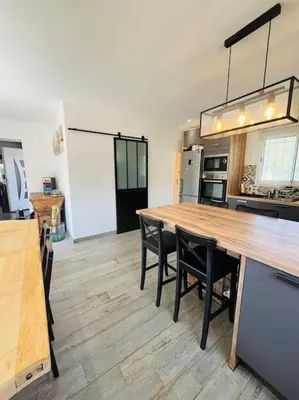 a kitchen with a large wooden table and chairs at Charmante Villa avec Piscine in Appietto