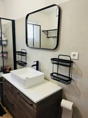a bathroom with a white sink and a mirror at Charmante Villa avec Piscine in Appietto