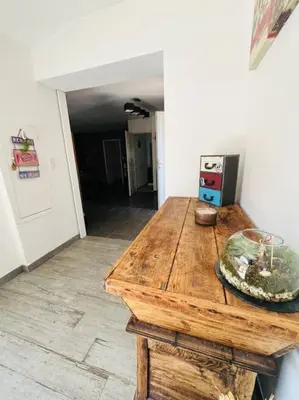 a room with a wooden table in a room at Charmante Villa avec Piscine in Appietto