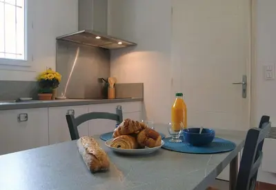 a table with a bowl of bread and a plate of food at Villa A Funtanella 100m2, paisible, vue mer in Conca