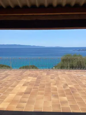 a view of the ocean from a balcony at Maison DE VACANCES VUE MER PROCHE PLAGE AJACCIO SANGUINAIRES REF 1070 in Ajaccio