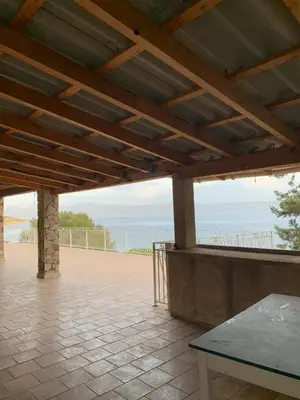 a large patio with a view of the ocean at Maison DE VACANCES VUE MER PROCHE PLAGE AJACCIO SANGUINAIRES REF 1070 in Ajaccio