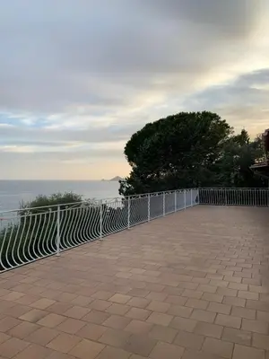 a white fence next to the ocean at Maison DE VACANCES VUE MER PROCHE PLAGE AJACCIO SANGUINAIRES REF 1070 in Ajaccio