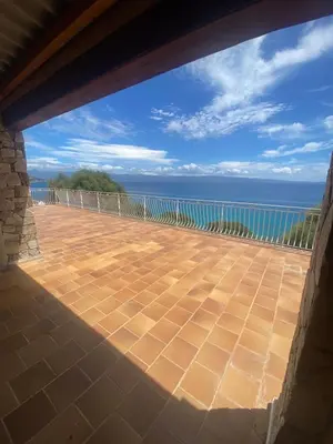 a view of the ocean from the balcony of a house at Maison DE VACANCES VUE MER PROCHE PLAGE AJACCIO SANGUINAIRES REF 1070 in Ajaccio