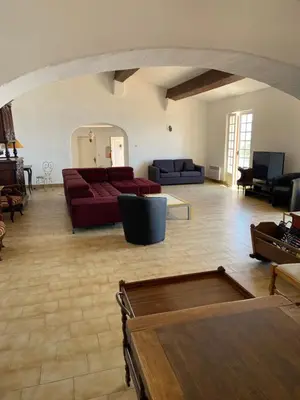 a large living room with couches and a table at Maison DE VACANCES VUE MER PROCHE PLAGE AJACCIO SANGUINAIRES REF 1070 in Ajaccio