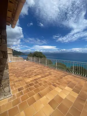 a balcony with a view of the ocean at Maison DE VACANCES VUE MER PROCHE PLAGE AJACCIO SANGUINAIRES REF 1070 in Ajaccio