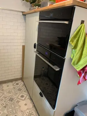 an oven with its door open in a kitchen at À casa nostra in Santo-Pietro-di-Tenda