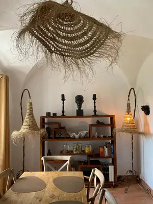 a dining room with a table and two lights at À casa nostra in Santo-Pietro-di-Tenda