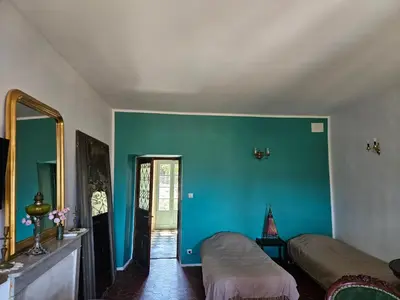 a room with two beds and a blue wall at A Casa Di a Vita in Rapale