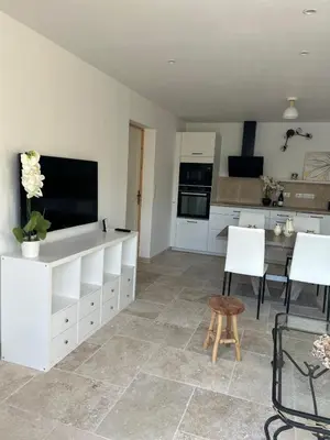 a kitchen with a large white cabinet with a flat screen tv at La maison du Soleil in Porticcio
