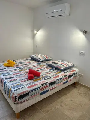 a bed with two stuffed animals sitting on top of it at La maison du Soleil in Porticcio
