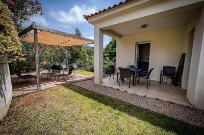 a patio with a table and chairs and an umbrella at Ambre - Terrace Garden - by TGB in Albitreccia
