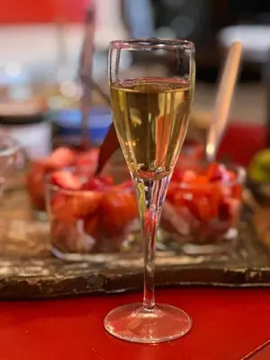 a glass of champagne sitting on a table at Mountain Lodge Corse Odyssée in Quenza