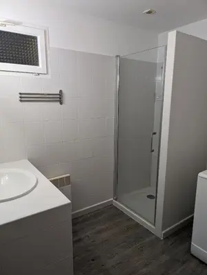 a bathroom with a shower and a sink at Appartement T2 bord de plage in Sartène