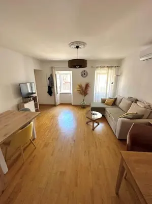 a living room with a couch and a table at T2 hyper centre ville in Ajaccio