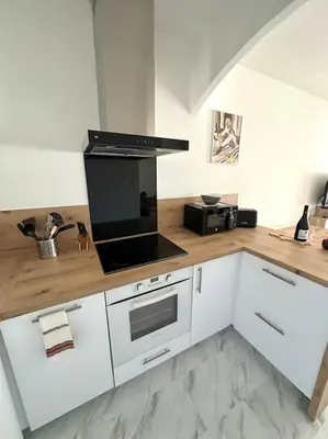 a kitchen with a counter with a stove top oven at T2 hyper centre ville in Ajaccio