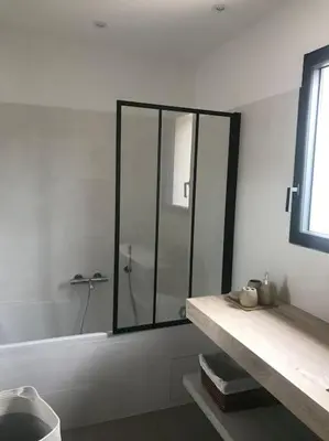 a bathroom with a glass shower and a sink at Villa privée-piscine-vue mer-pinarello-cirindinu in Zonza