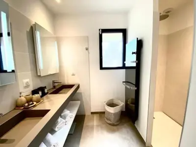 a white bathroom with two sinks and a window at Villa privée-piscine-vue mer-pinarello-cirindinu in Zonza