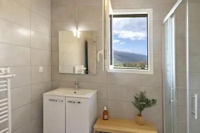 a bathroom with a sink and a mirror and a window at Casa Ornella in Vescovato