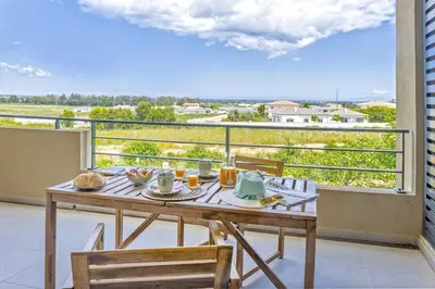 a table on a balcony with a view of the ocean at Casa Ornella in Vescovato