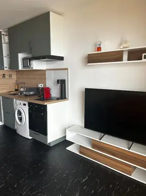 a small kitchen with a stove and a microwave at Studio climatisé belle vue mer in Ajaccio